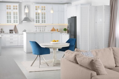 Stylish studio apartment interior with comfortable beige sofa