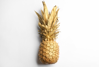 Photo of Painted golden pineapple on white background, top view. Creative concept