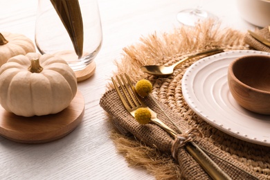 Photo of Autumn table setting and pumpkin on white wooden background