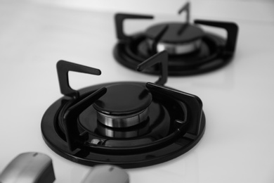 Photo of Modern built-in gas cooktop, closeup. Kitchen appliance