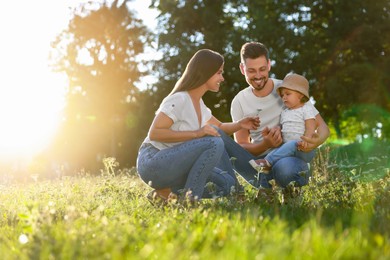 Photo of Happy cute family in park on sunny day. Space for text