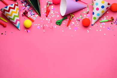 Beautiful flat lay composition with festive items on pink background, space for text. Surprise party concept
