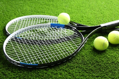 Tennis rackets and balls on green grass. Sports equipment