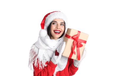 Woman in Santa hat, knitted mittens, scarf and red sweater holding Christmas gift on white background