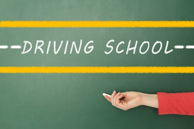  Driving school concept. Woman with white chalk near green board, closeup