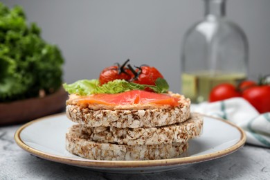 Crunchy buckwheat cakes with salmon, tomatoes and greens on table