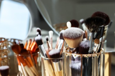 Photo of Set of professional brushes and mirror, closeup