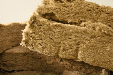Heap of thermal insulation material on grey background, closeup