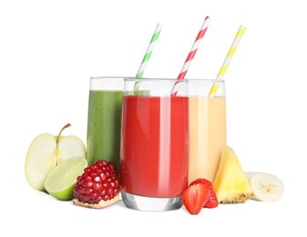 Glasses with delicious smoothies and ingredients on white background
