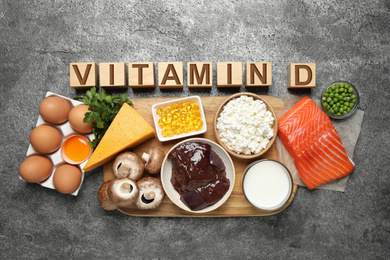 Photo of Flat lay composition with products rich in vitamin D on grey table