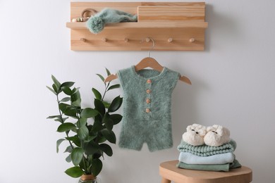 Cute children's clothes and shoes in room