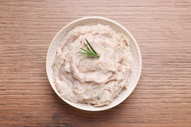 Photo of Delicious lard spread in bowl on wooden table, top view