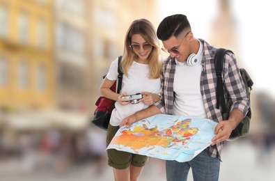 Couple of travelers with map in foreign city. Summer vacation trip
