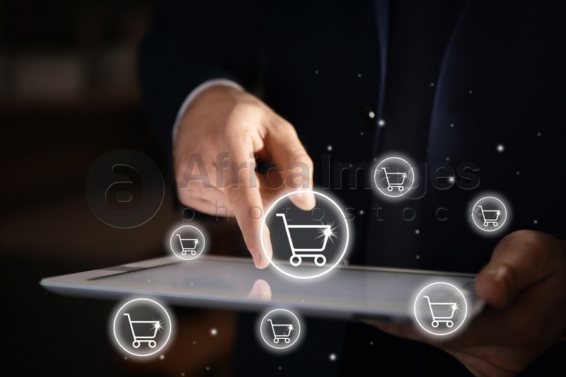Delivery concept. Man using modern tablet for online shopping indoors, closeup. Market cart illustrations