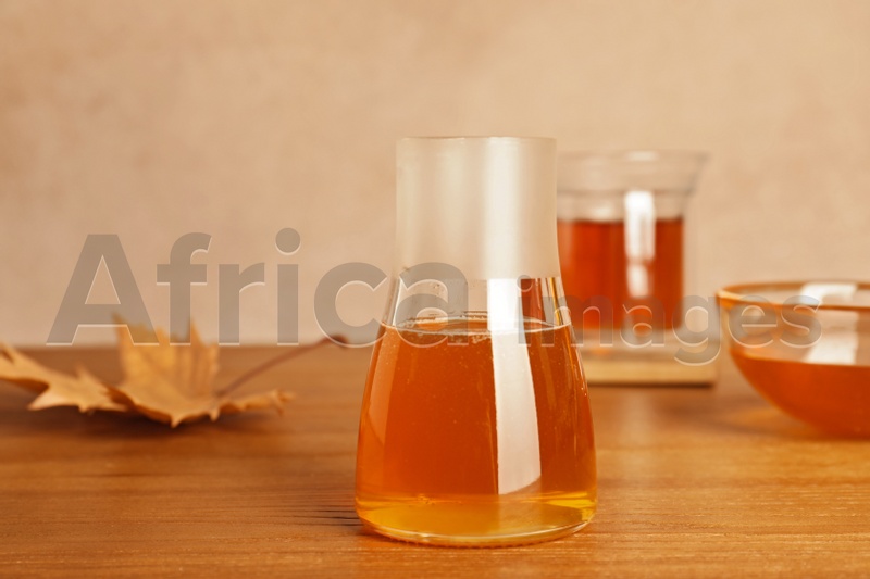 Photo of Glass jar with tasty honey on wooden table