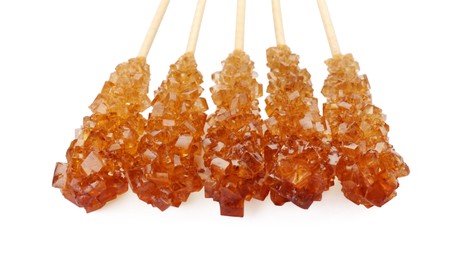 Wooden sticks with sugar crystals isolated on white, closeup. Tasty rock candies