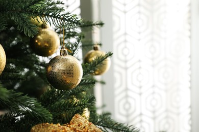 Beautifully decorated Christmas tree in room, closeup. Space for text