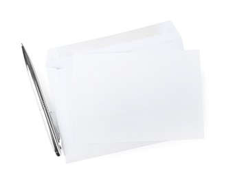 Envelope with blank letter and pen on white background, top view