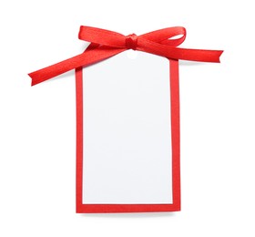 Blank gift tag with red satin ribbon on white background, top view