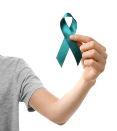 Woman holding teal awareness ribbon against white background, closeup