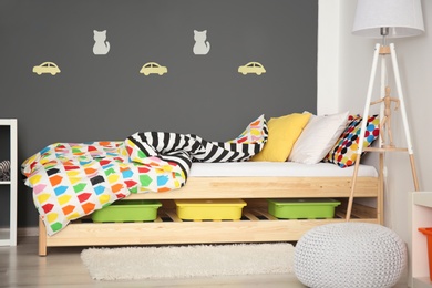 Modern room interior with comfortable bed for child