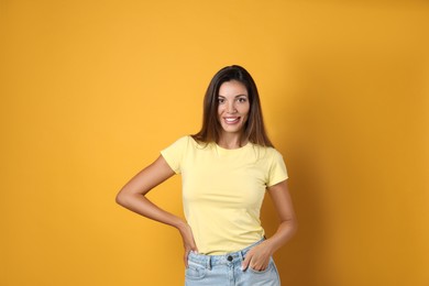 Portrait of beautiful woman on yellow background