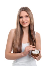 Young woman with coconut oil for hair on white background