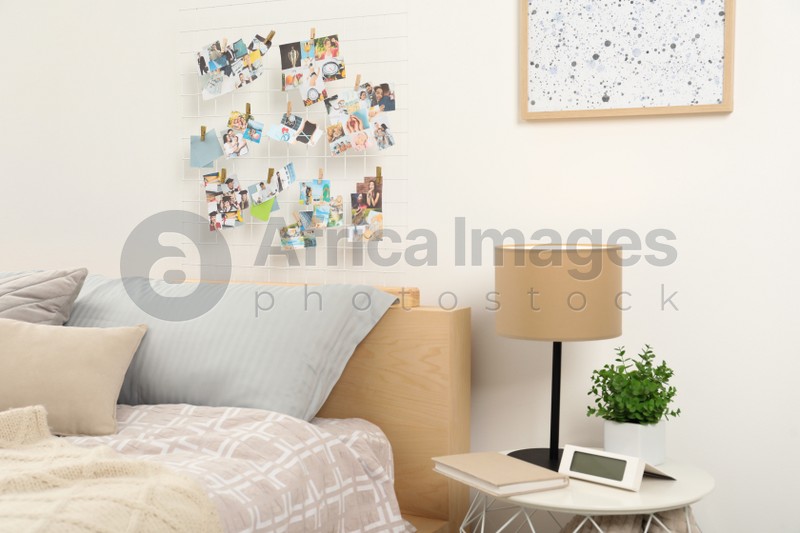 Stylish room interior with comfortable bed and vision board on wall