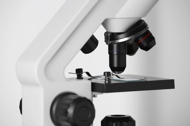 Modern microscope on light background, closeup. Medical equipment