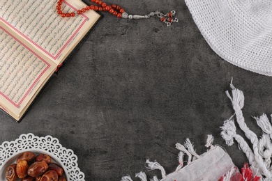 Flat lay composition with Muslim prayer beads, Quran and space for text on grey background