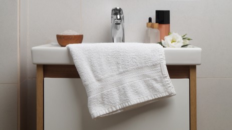 White soft towel on sink in bathroom