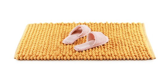 New yellow bath mat with soft slippers isolated on white