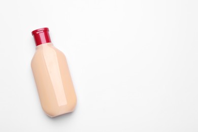 Bottle of shampoo on white background, top view. Space for text