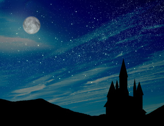 Fairy tale. Magnificent castle under starry sky with full moon at night