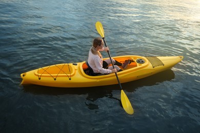 Young woman kayaking in river. Summer activity