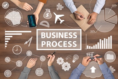 Image of Discussing business process. People and different illustrations on wooden background, top view