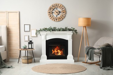 Stylish room decorated with beautiful eucalyptus garland on fireplace