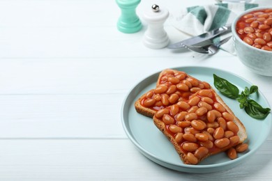 Toasts with delicious canned beans on white wooden table, space for text