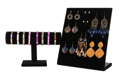 Different display stands with stylish jewelry on white background