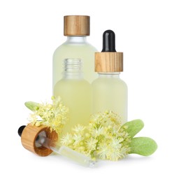 Bottles of essential oil and linden flowers on white background