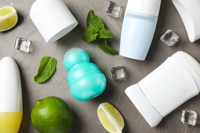 Flat lay composition with female roll-on deodorants on grey table