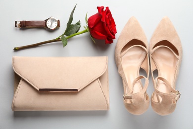 Stylish shoes, flower and accessories on light grey background, flat lay