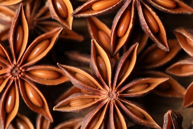 Many aromatic anise stars on table, flat lay