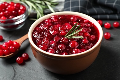 Cranberry sauce in bowl on dark grey table