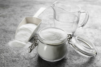 Baking soda in glass jar on grey table