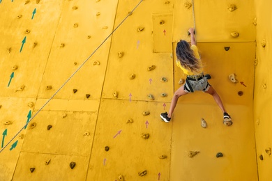 OCHAKIV, UKRAINE - JULY 09, 2020: Girl on climbing wall in summer camp "Sportium", back view