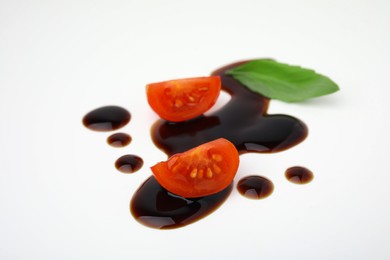 Photo of Tomatoes, basil leaf and balsamic vinegar on white background