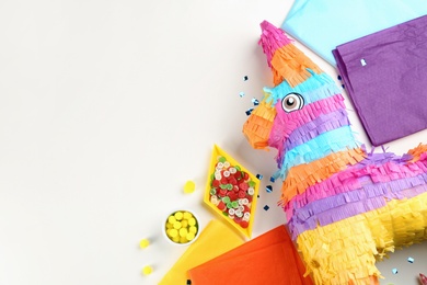 Flat lay composition with cardboard donkey and materials on white background, space for text. Pinata DIY