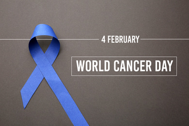 Blue ribbon on grey background, top view. World Cancer Day