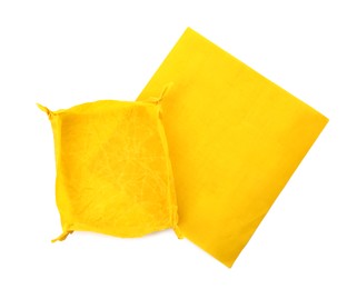 Yellow beeswax food wraps on white background, top view